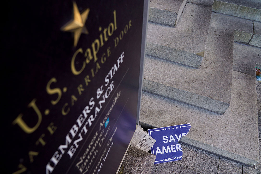 Scraps of a demonstrator's poster lays near the Senate Carriage Entrance of the U.S. Capitol in Washington Jan. 7, 2021, a day after hundreds of supporters of President Donald Trump occupied the Capitol. (CNS/Erin Scott, Reuters) Scraps of a demonstrator's poster lays near the Senate Carriage Entrance of the U.S. Capitol in Washington Jan. 7, 2021, a day after hundreds of supporters of President Donald Trump occupied the Capitol. (CNS/Erin Scott, Reuters)
